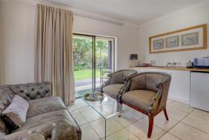 a living room with two chairs and a couch at Stay Wilderness in Wilderness