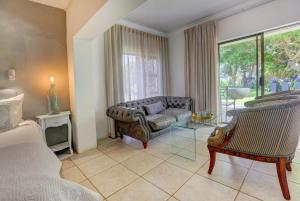 a living room with a couch and a chair at Stay Wilderness in Wilderness