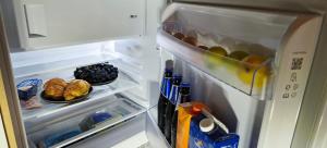 an open refrigerator filled with lots of food and drinks at Red Room Luxury puhkemaja in Kooli