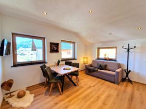 a living room with a table and a couch at Apartment Wildschütz by Interhome in Weerberg