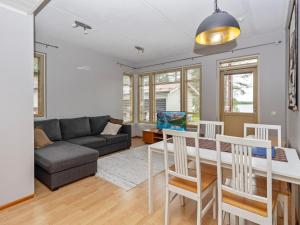 a living room with a table and a couch at Holiday Home Rantala 2 by Interhome in Ranua