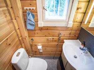 a bathroom with a white toilet and a sink at Holiday Home Villa white water by Interhome in Kainuu