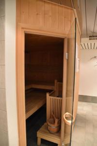 a sauna with a glass door in a room at Apartment Dominic B2 by Interhome in Saas-Fee