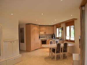 a kitchen with a table and chairs in it at Apartment Dominic B2 by Interhome in Saas-Fee