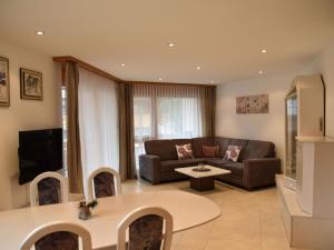 a living room with a couch and a table at Apartment Dominic B2 by Interhome in Saas-Fee