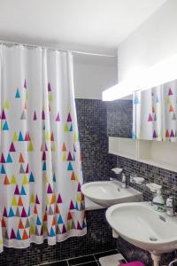 a bathroom with a shower curtain and a sink at Apartment Curnera 9-4 by Interhome in Laax-Murschetg