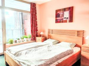 a bedroom with a large bed with a window at Studio Čertovka-3 by Interhome in Harrachov