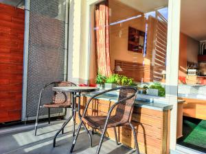 a patio with a table and chairs on a balcony at Studio Čertovka-3 by Interhome in Harrachov