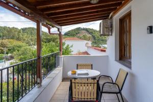 a patio with a table and chairs on a balcony at Amalia Studios Skiathos in Skiathos Town