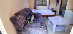 a living room with a couch and a bed at Smooth Landing in Ukunda