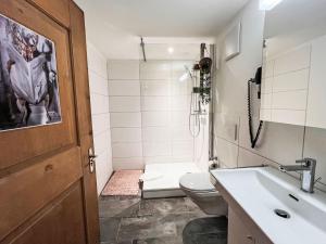 a bathroom with a toilet and a sink at Apartment Edelweiss-Stube by Interhome in Klosters Serneus