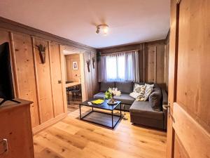 a living room with a couch and a table at Apartment Edelweiss-Stube by Interhome in Klosters Serneus