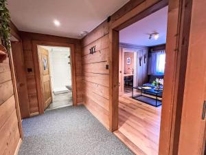 an empty room with wooden walls and a door at Apartment Edelweiss-Stube by Interhome in Klosters Serneus
