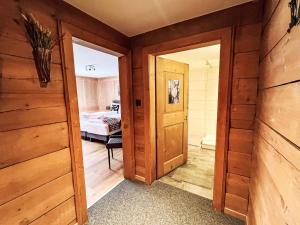 an open door in a room with a bedroom at Apartment Edelweiss-Stube by Interhome in Klosters Serneus +3 photos