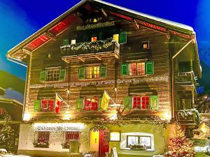 a house with christmas lights on the side of it at Apartment Steinbock-Stube by Interhome in Klosters