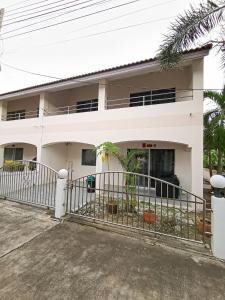 a white house with a fence in front of it at Townhome 45 in Ban Nong Pru