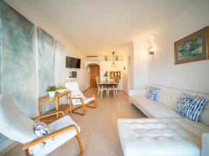 a living room with a couch and a table at Apartment Carabela Chic by Interhome in Alcudia