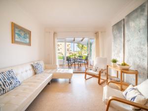 a living room with a white couch and chairs at Apartment Carabela Chic by Interhome in Alcudia