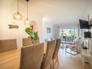 a dining room and living room with a table and chairs at Apartment Carabela Chic by Interhome in Alcudia +15 photos