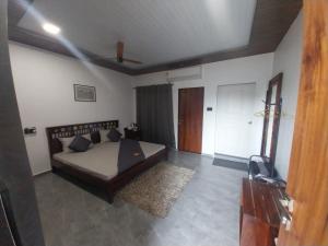 a bedroom with a bed and a tv in it at The KaMP in Murbād +3 photos