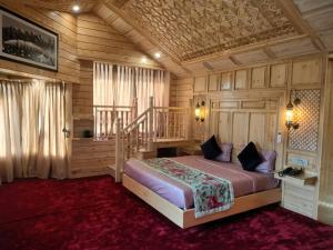 a bedroom with a bed and a staircase in a room at Kashmir Mahal Resorts by Stay Pattern in Srinagar
