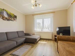 a living room with a couch and a television at Apartment Pajtas 2 by Interhome in Balatonfenyves