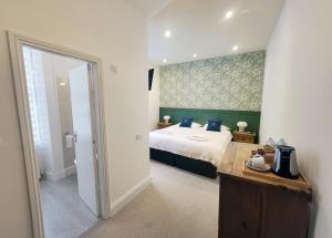 Ένα ή περισσότερα κρεβάτια σε δωμάτιο στο Kings' House