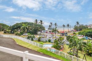 a view of a road and a beach with palm trees at 10 Gleneagles, Salt Rock in Ballito