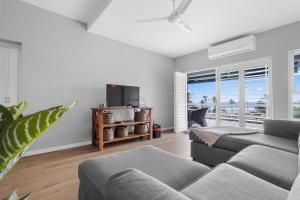 a living room with a couch and a tv at 10 Gleneagles, Salt Rock in Ballito
