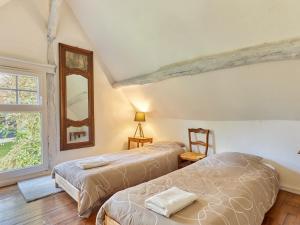 En eller flere senge i et værelse på Holiday Home La Ferme by Interhome