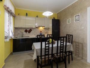 a kitchen with a table and chairs and a sink at Holiday Home Adele by Interhome in Labin