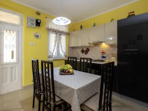 a kitchen with a table with a bowl of fruit on it at Holiday Home Adele by Interhome in Labin +21 photos