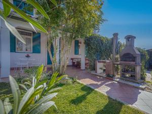 a garden with a fireplace and a house at Holiday Home Adele by Interhome in Labin