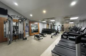 a gym with a bunch of treadmills and machines at Apex Dunblane Hydro in Dunblane
