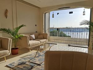 a living room with two couches and a large window at ElMena House Luxor in Luxor