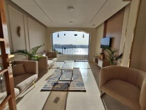 a living room with couches and a table at ElMena House Luxor in Luxor