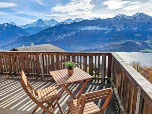 a table and two chairs on a balcony with mountains at Apartment Möösli Vue by Interhome in Sundlauenen