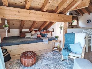 a bed in a room with a wooden ceiling at Apartment Möösli Vue by Interhome in Sundlauenen