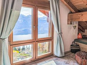 a room with a large window with a view of a mountain at Apartment Möösli Vue by Interhome in Sundlauenen +25 photos