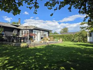 Holiday Home Yvette - 350m from the sea by Interhome في Hejlsminde: منزل مع فناء وساحة عشبية