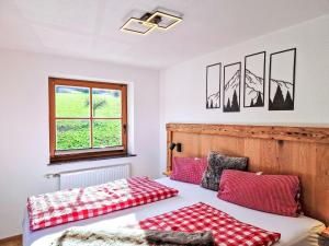 a bedroom with two beds and a window at Apartment Almluft by Interhome in Weerberg