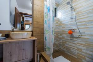 a bathroom with a sink and a shower at Chilia Houses in Mănăstirea Humorului +22 photos