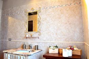 a bathroom with a sink and a mirror at Mi casa es tu casa 79 in Portoscuso