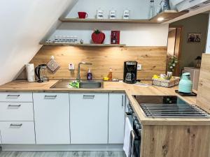 a kitchen with white cabinets and a sink at Apartment Die Dorfperle by Interhome in Wanna