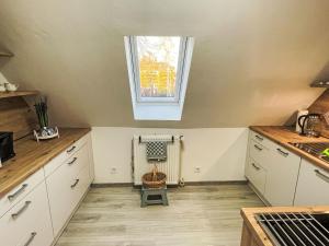 a kitchen with white cabinets and a window at Apartment Die Dorfperle by Interhome in Wanna +23 photos