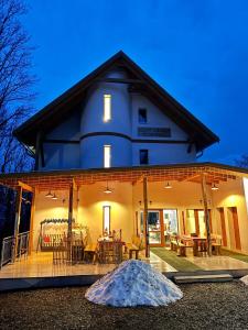 a large white house with a table and chairs at Szent László Residence in Mátraszentimre