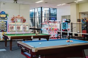 a room with two pool tables and a machine at The Reserve Hotel in Sale