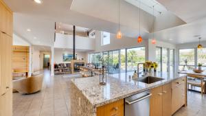 an open kitchen with a large island and a living room at Coplan Vineyards by AvantStay 10-Acre Estate w Pool Spa Bocce Designer Interiors in Sonoma