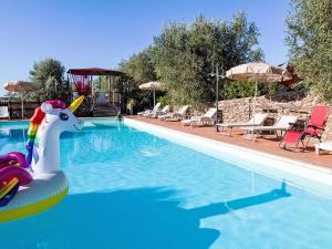 a swimming pool with a unicorn in the water at Apartment Erica by Interhome in Venturina Terme
