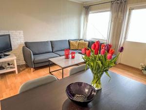 a living room with a vase of flowers on a table at Apartment Samlen Vasselgård by Interhome in Herand